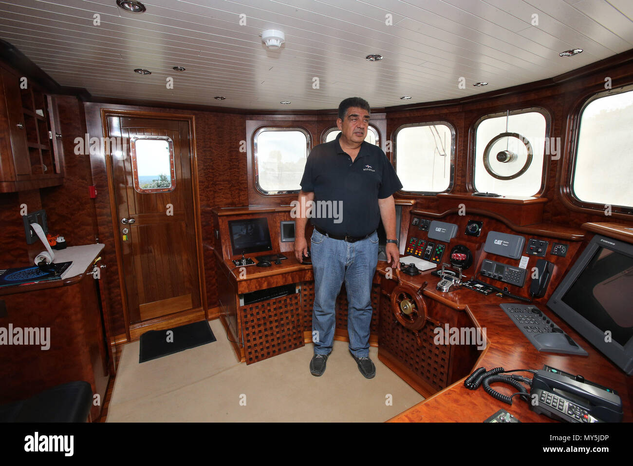 (180606) -- ATHENS, June 6, 2018 (Xinhua) -- Captain Sarantis Kountouris stands at the bridge of 'Neraida' Floating Museum in Piraeus, Greece, on June 5, 2018. 'Neraida', the only seaworthy floating museum in Greece, is berthed in Pireaus to participate in the Sea Days events. (Xinhua/Marios Lolos)(jmmn) Stock Photo