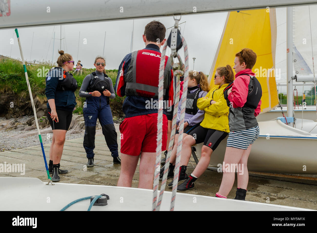 Schull, Ireland. 6th June, 2018. After a dull and overcast start this morning, the sun will burn off the clouds and make an appearance this afternoon giving highs of 21 C. Participants undertaking a Dinghy Instructor Course at Fastnet Marine Outdoor Education Centre in Schull listen to a safety briefing as part of their training.  Credit: Andy Gibson/Alamy Live News. Stock Photo