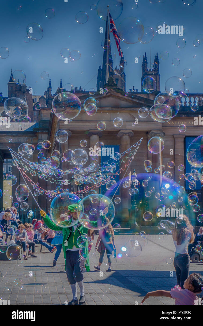 Edinburgh, Scotland. 6th June, 2018. A man blows masses of soapy bubbles for children at the Mound in Edinburgh. Credit: Dougie Milne Photography/Alamy Live News Stock Photo