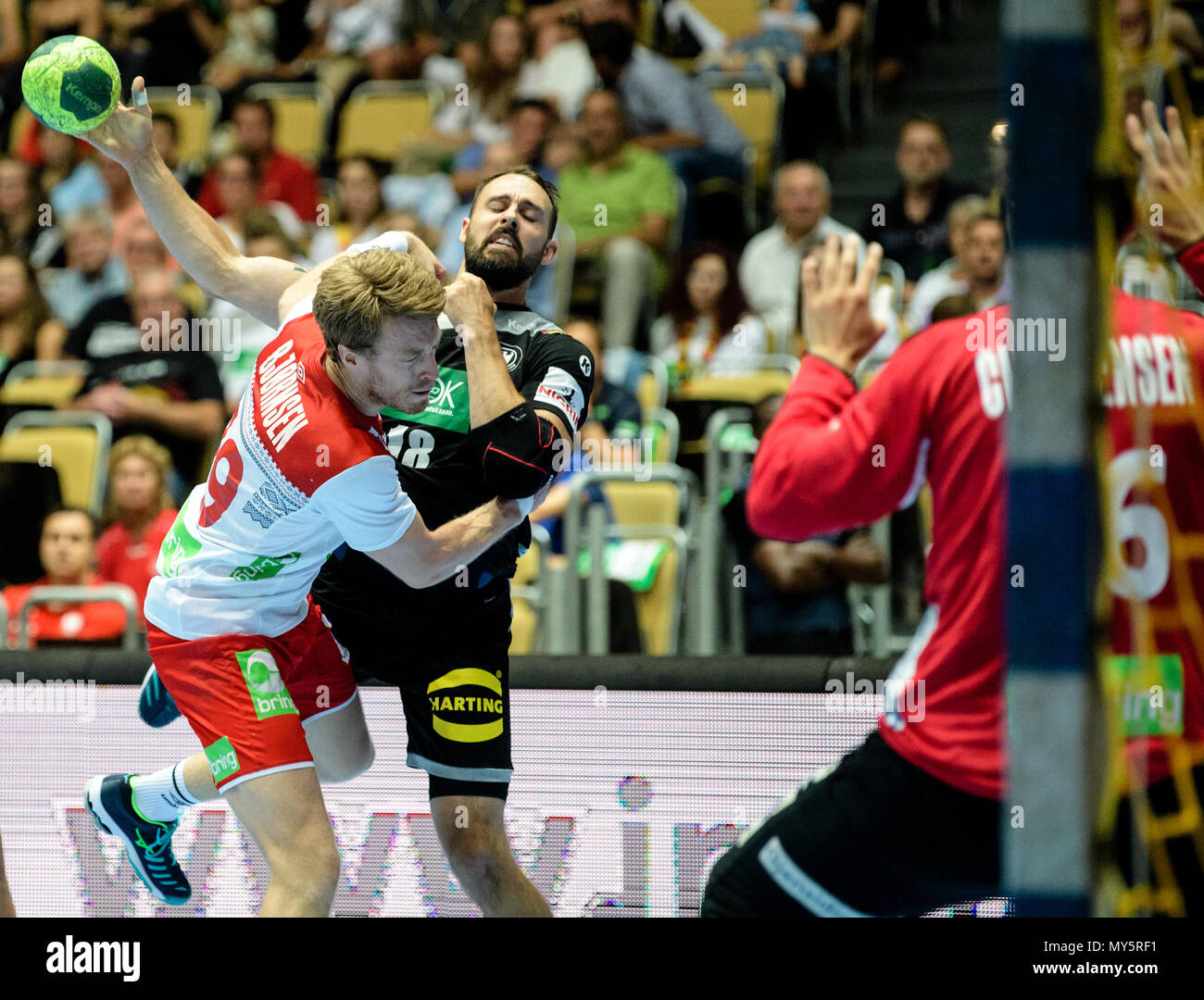 06 June 2018, Germany, Munich: Handball, men, international match, Germany vs Norway in the Olympic Hall. Germany's Tim Kneule (R) fighting for the ball against Norway's Kristian Björnsen. On the right is Norway's goalkeeper Espen Christensen. Photo: Matthias Balk/dpa Stock Photo
