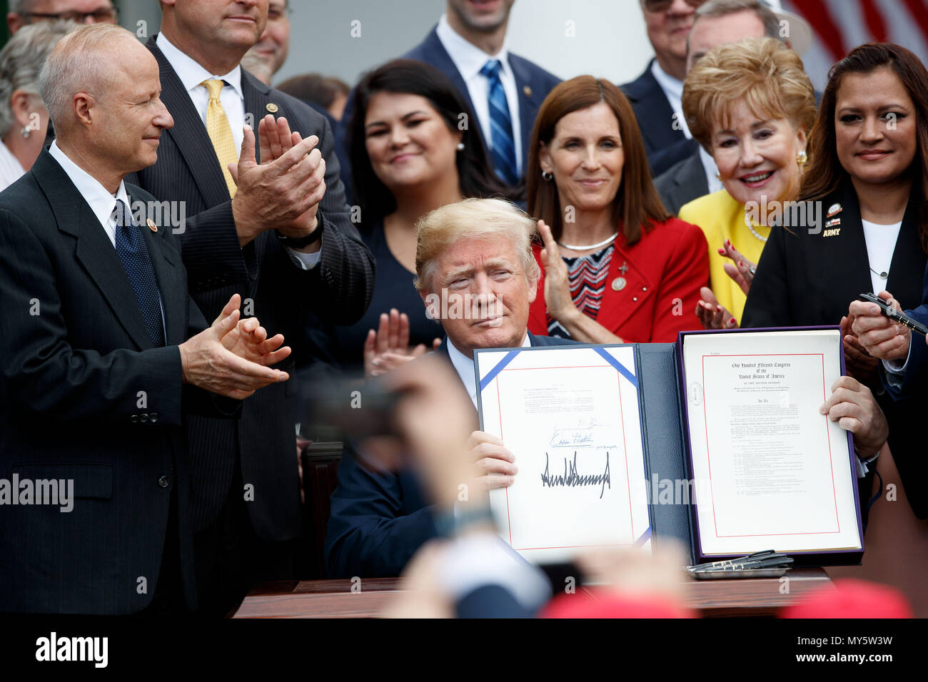 Washington, USA. 6th June, 2018. U.S. President Donald Trump (C) displays his signature during a bill signing ceremony for the 'VA Mission Act of 2018' in the Rose Garden of the White House in Washington, DC, the United States, on June 6, 2018. Credit: Ting Shen/Xinhua/Alamy Live News Stock Photo