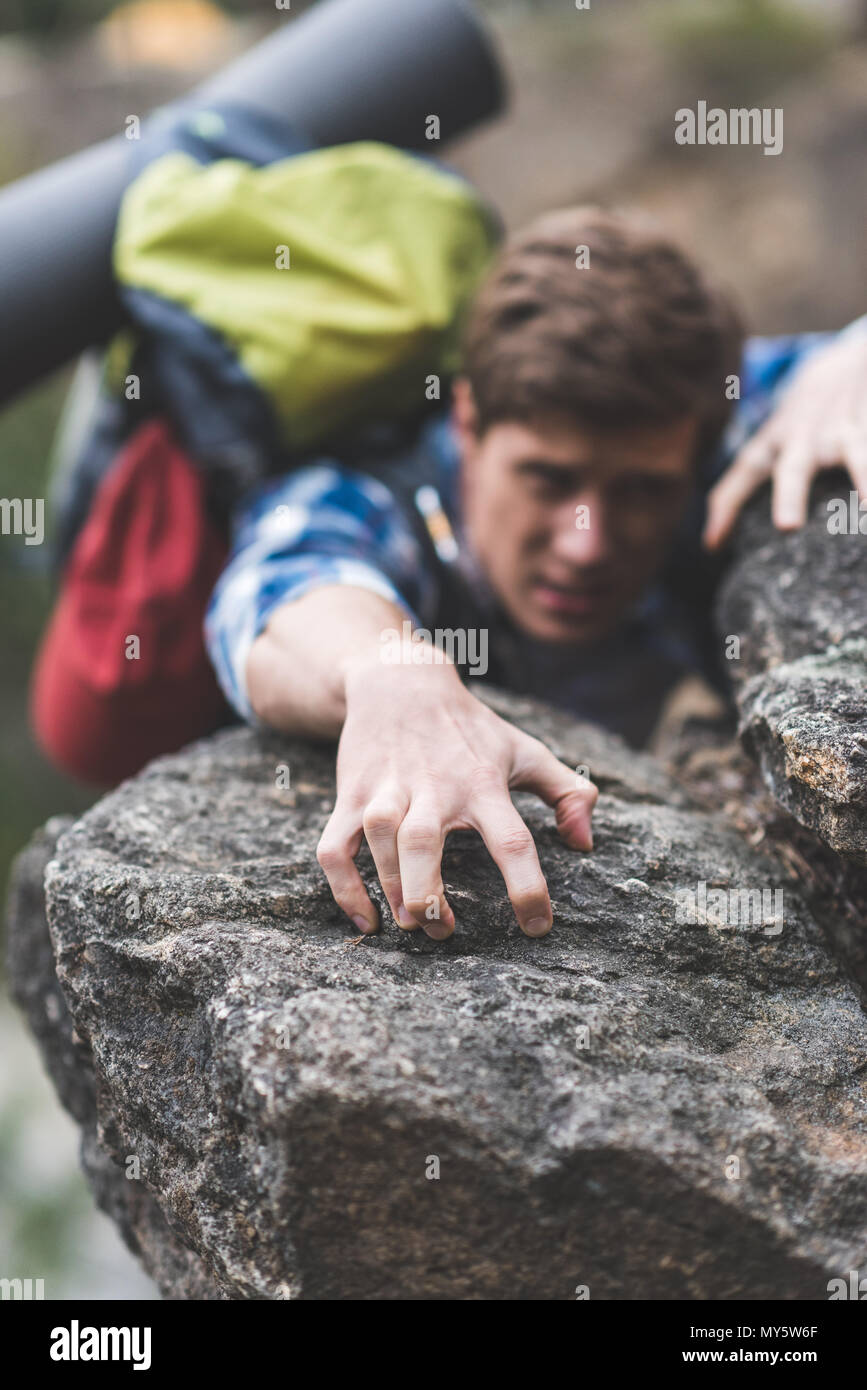 Young hiker climbing rocky cliff hi-res stock photography and images ...