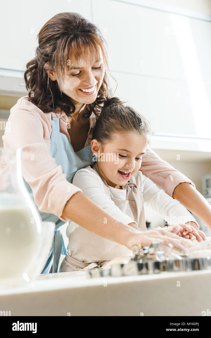 happy mother with daughter kneading dough at kitchen Stock Photo - Alamy