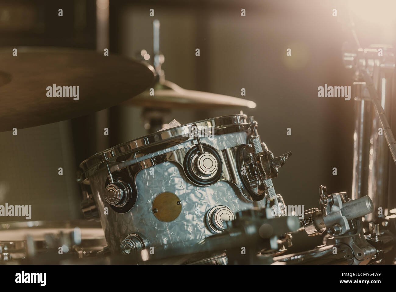 close-up shot of drum set under spotlight on stage Stock Photo - Alamy