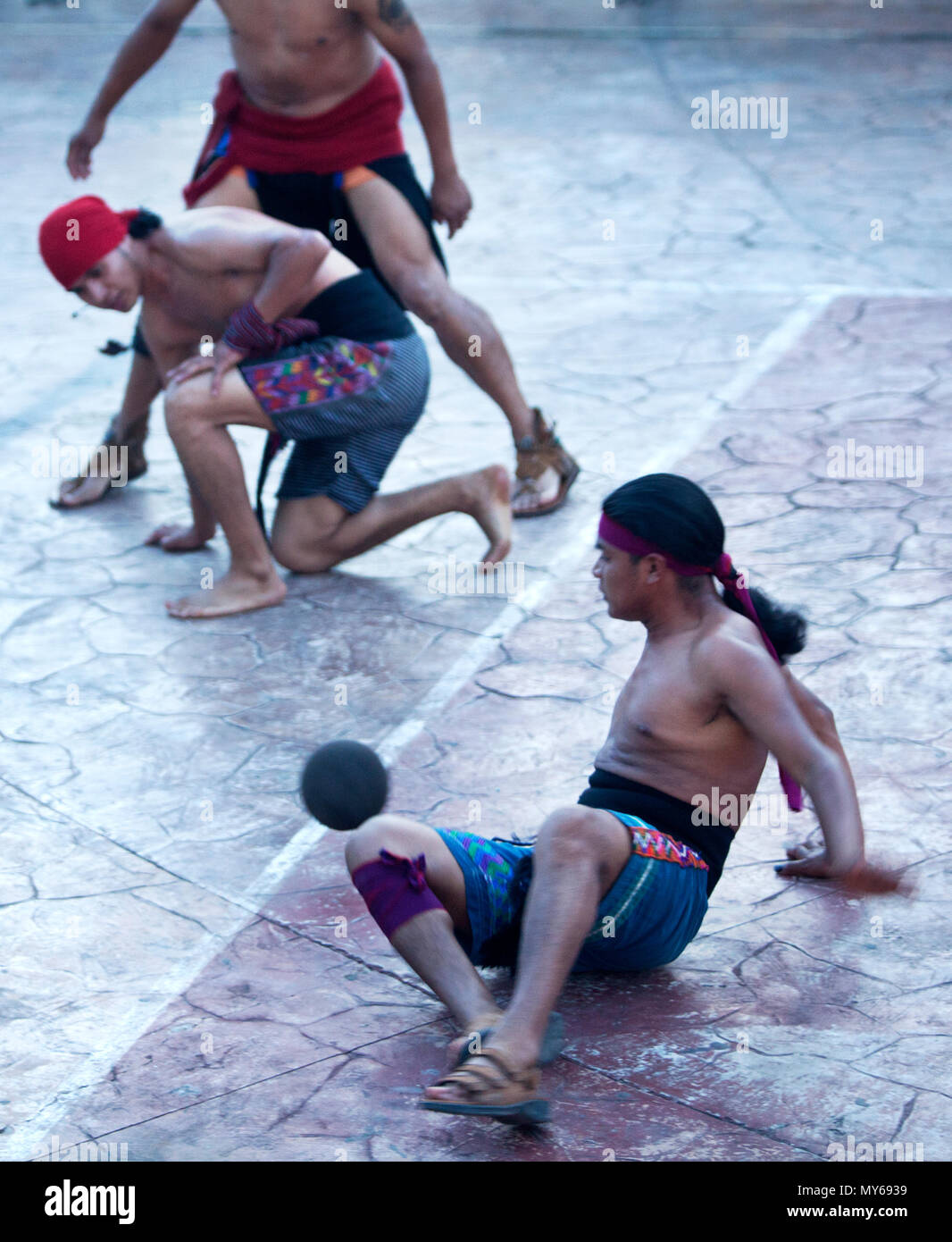 Guatemalan Mayan Ball Player Jose Cristal hits the ball with his hip as his brother Josue Cristal looks at him during the first ¬Pok Ta Pok¬ World Cup Stock Photo