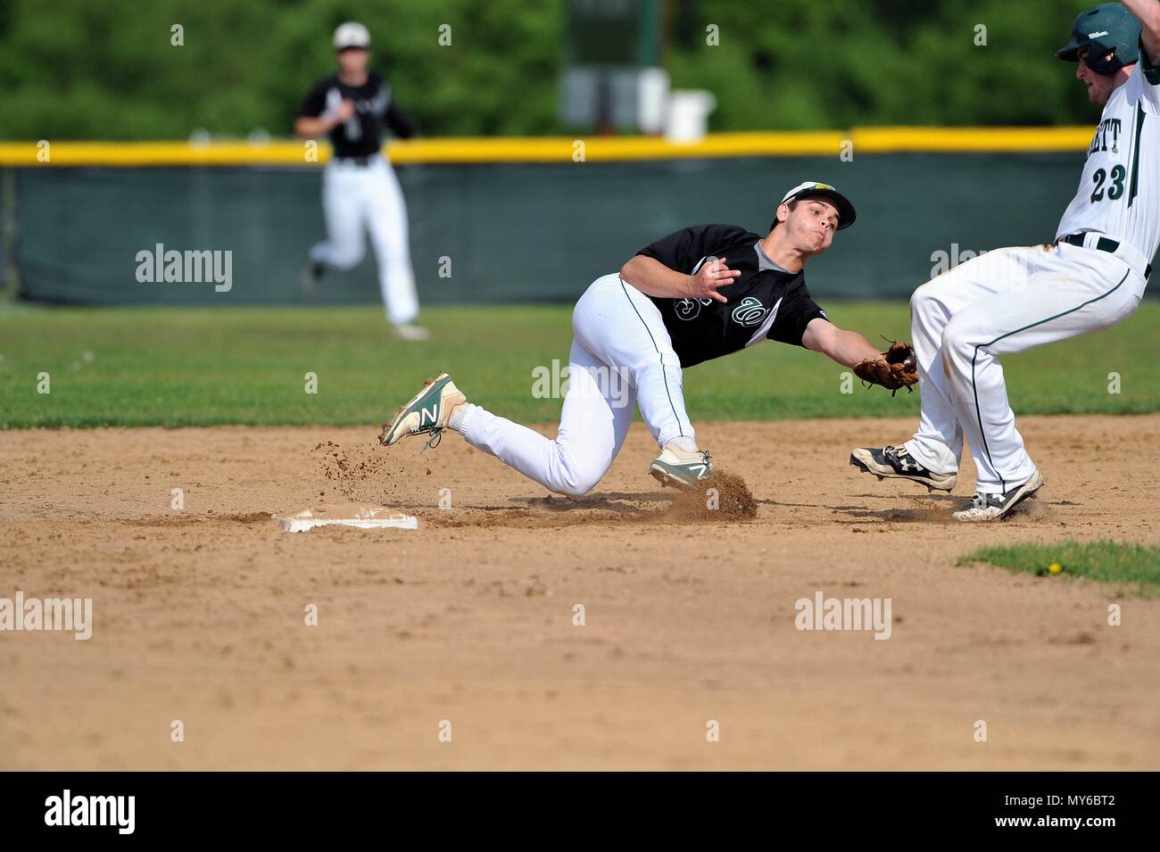 Middle infielder making a swipe tag on a runner attempting to so into second base with a double. USA Stock Photo