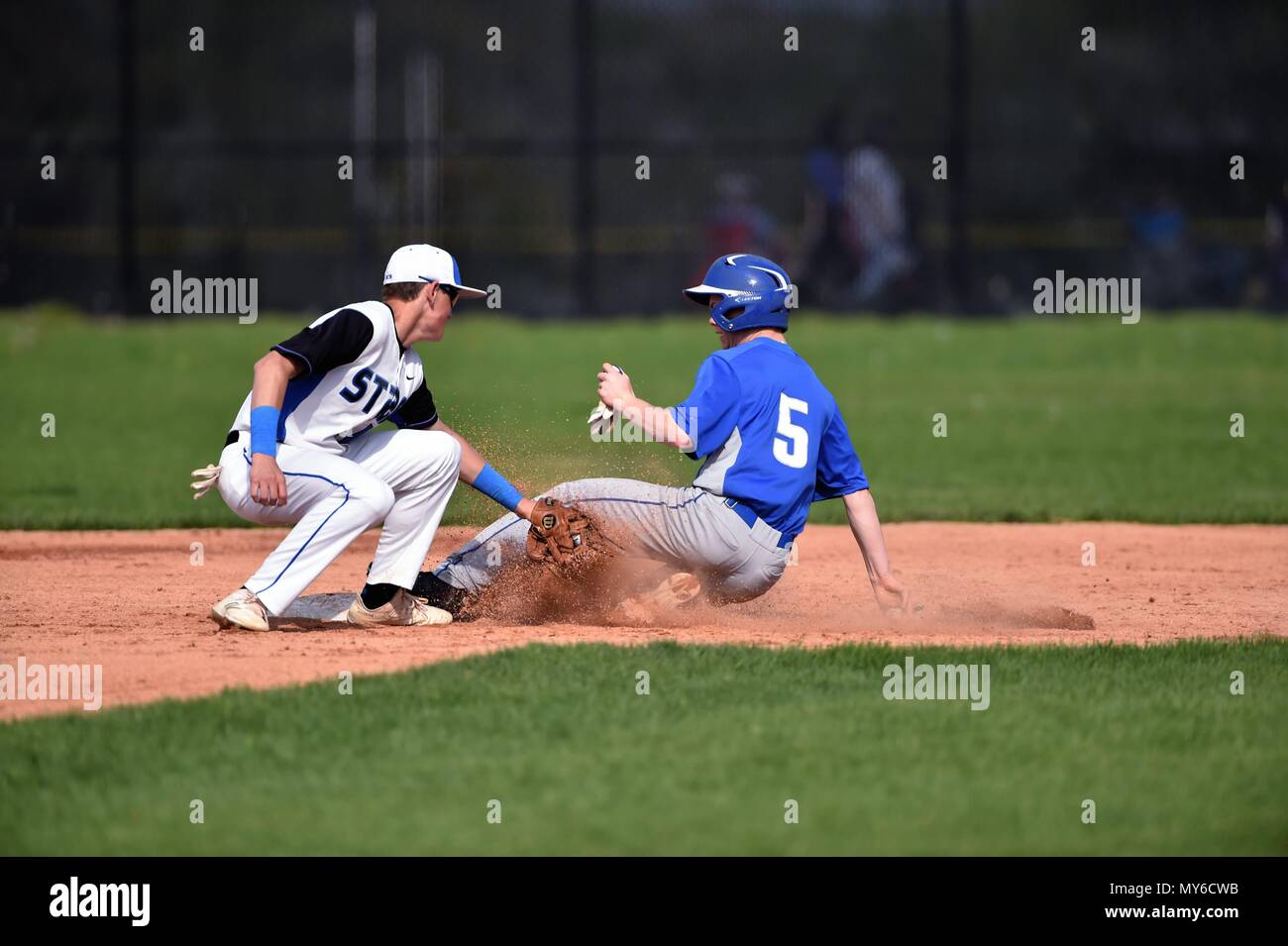 Middle infielder accepting a throw too late to prohibit an opponent base runner from stealing second base. USA. Stock Photo