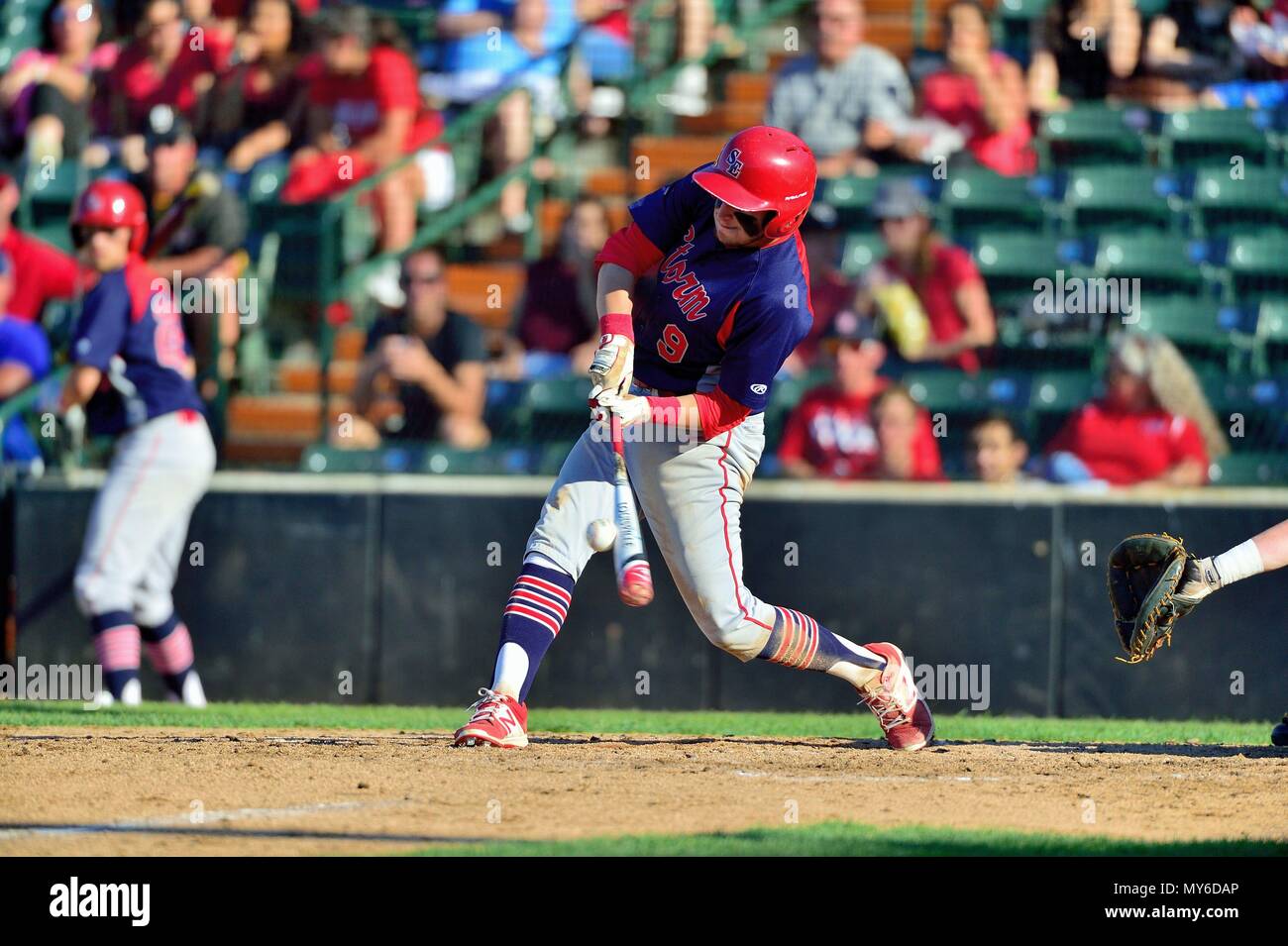 Hitter making solid contact as bat meets ball. USA. Stock Photo