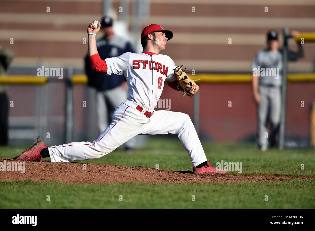Right-handed pitcher throwing to an opposing hitter during a high school baseball game. USA. Stock Photo
