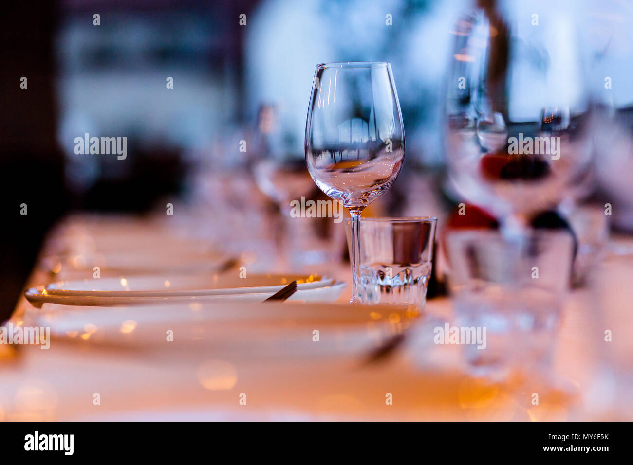 Luxury table settings for fine dining with and glassware, beautiful blurred  background. For events, weddings. Stock Photo