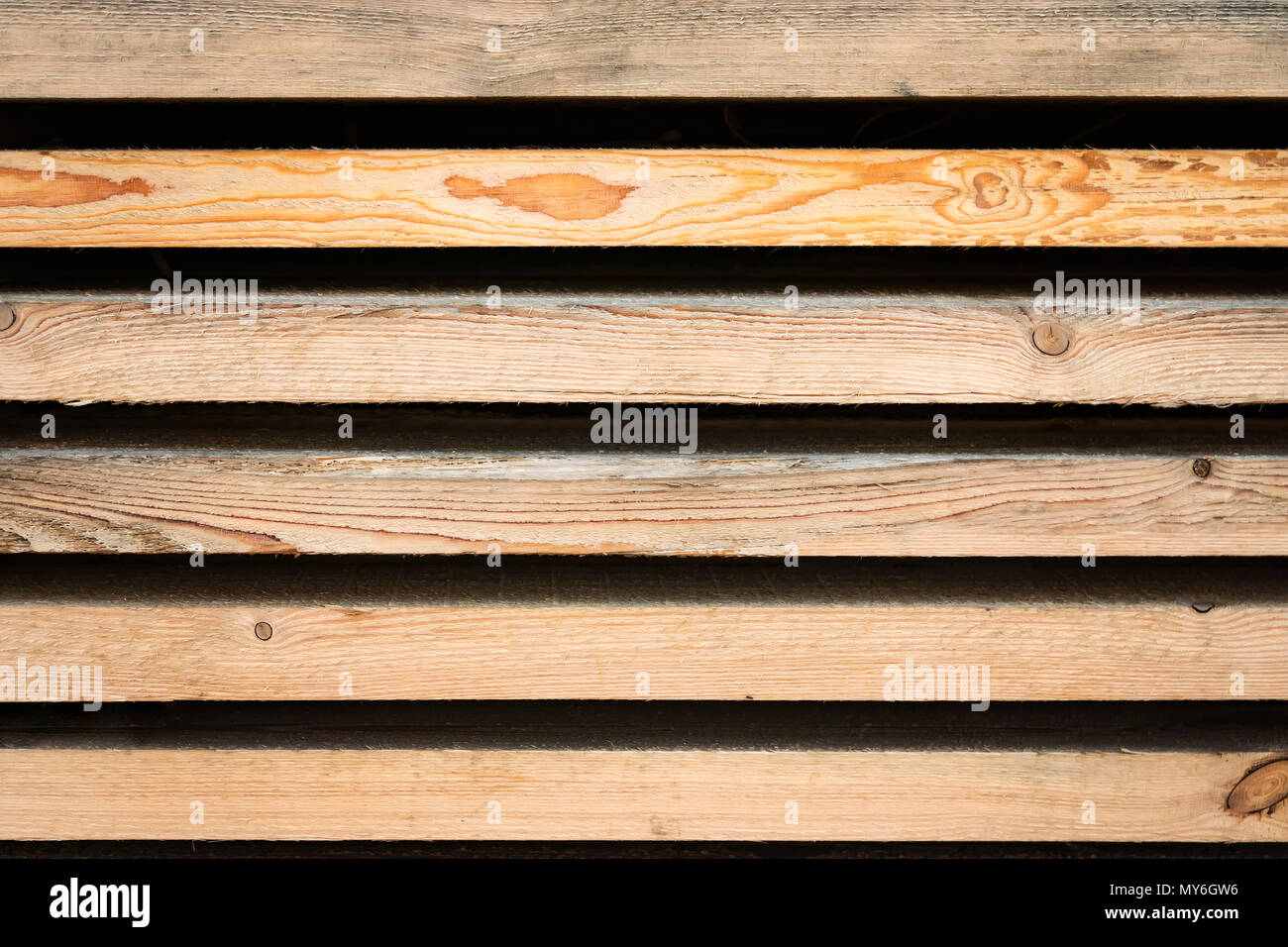 Strips of wooden boards on a black background. Wood lumber, Stock of