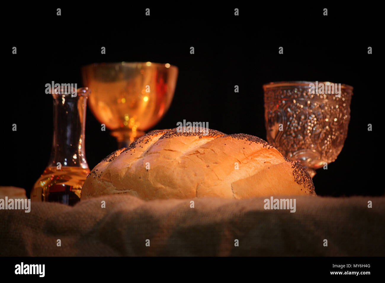 Bread wine holy blessed water on table for Easter liturgy mass with beautiful warm lighting. Image of christian symbols, religion and tradition. Lent Stock Photo