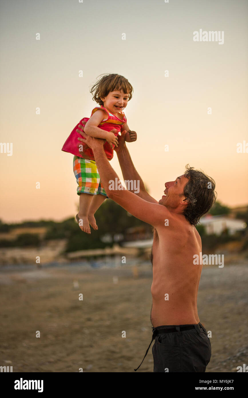 Father and his daughter having fun at the beach during summer holiday