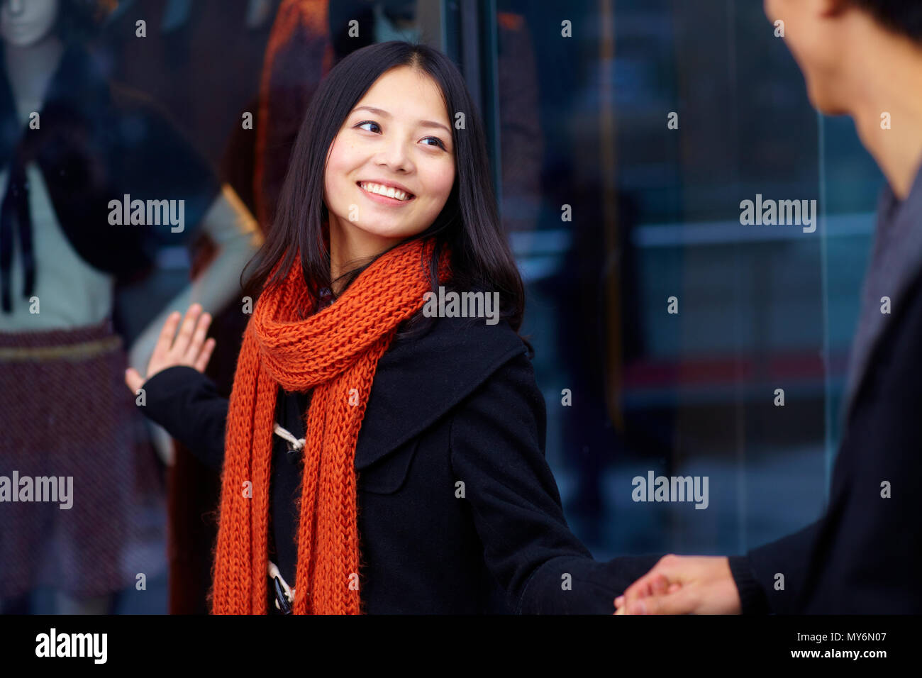 Happy young asian couple in the street shopping Stock Photo - Alamy