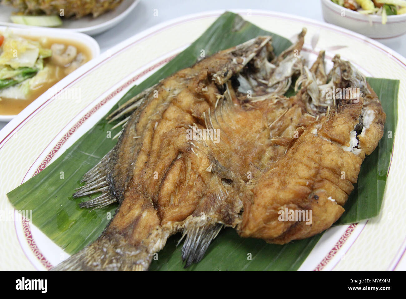 Thai fried Sea Bass on the banana leaf at Bangkok, Thailand Stock Photo