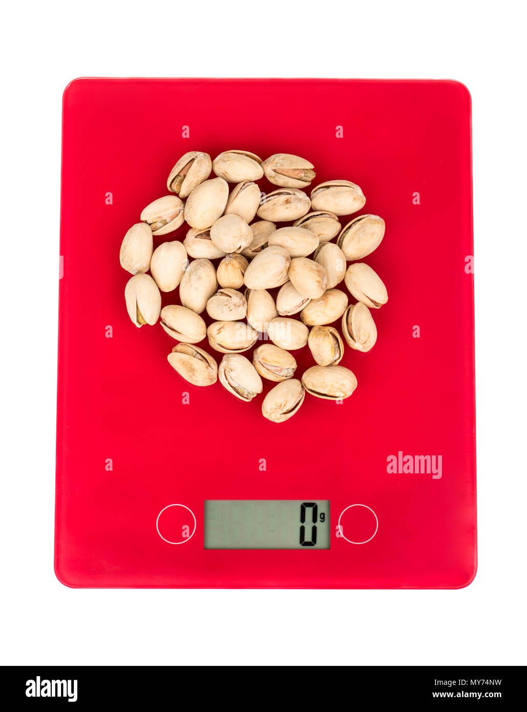 Pistachio nuts on kitchen scales isolated on white background, top view ...