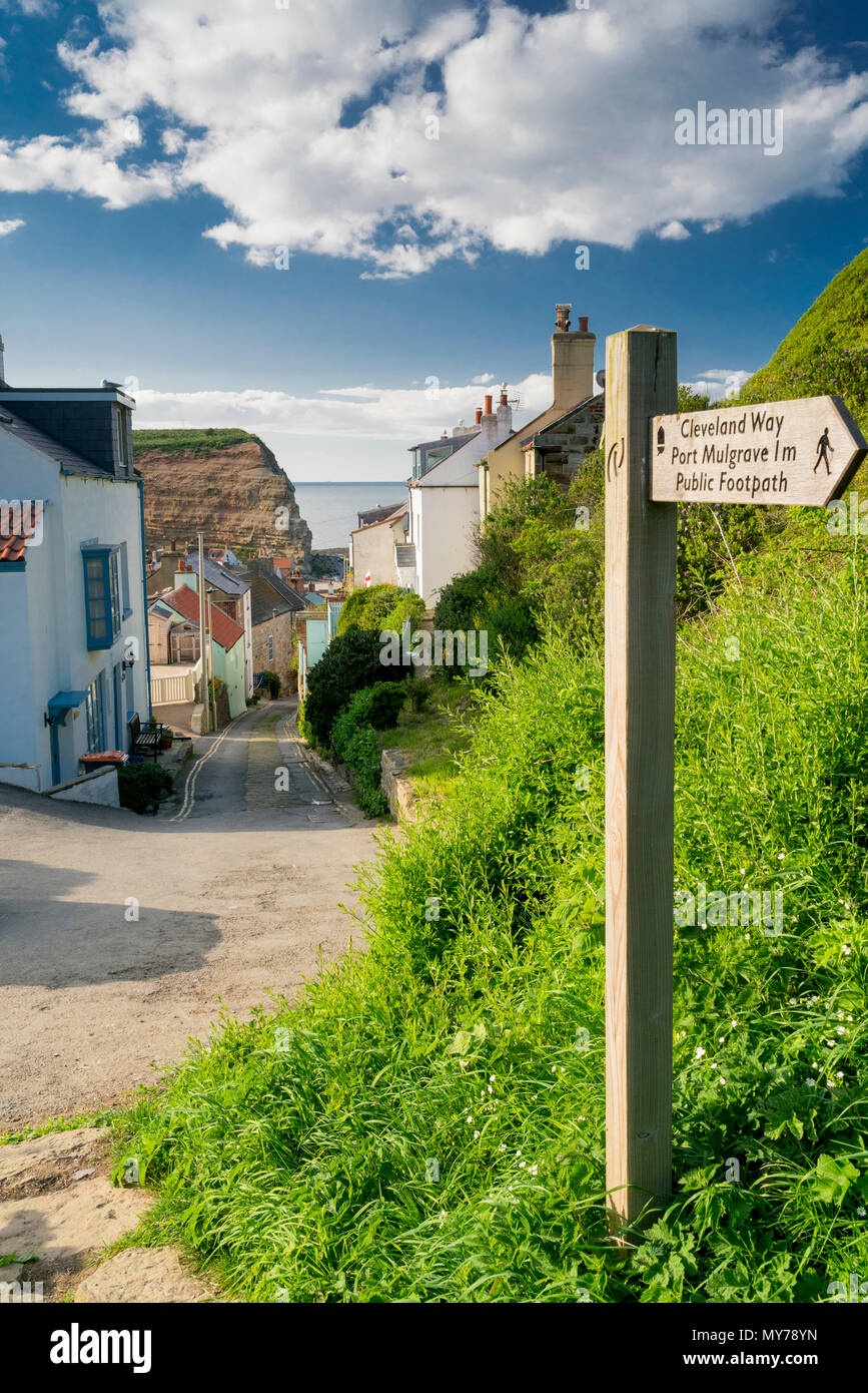 A signpost for the Cleveland Way at Staithes village on the North Yorkshire Heritage coastline Stock Photo