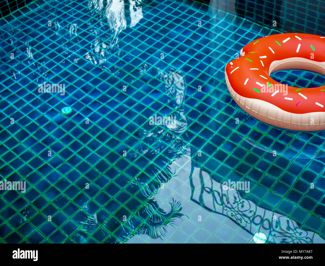 Pool Float Ring are Floating on Swimming Pool Background, Summer Concept Stock Photo