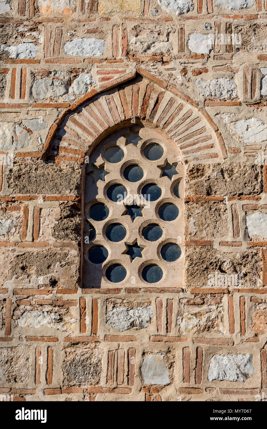 Ancient stone and ceramics arched window with Star of David and circles in a bright day Stock Photo