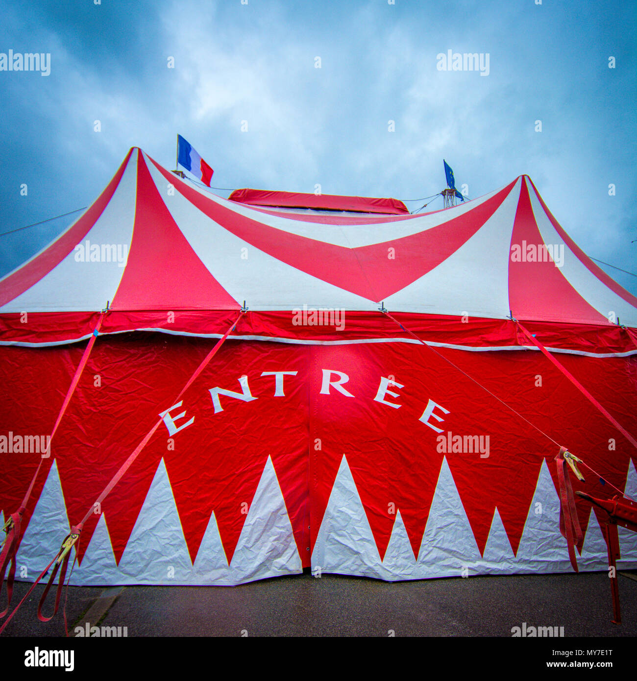 Bright red circus tent with striking design welcomes visitors at local ...