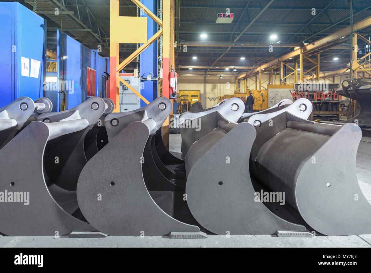 Row of digger buckets in detail in engineering factory Stock Photo