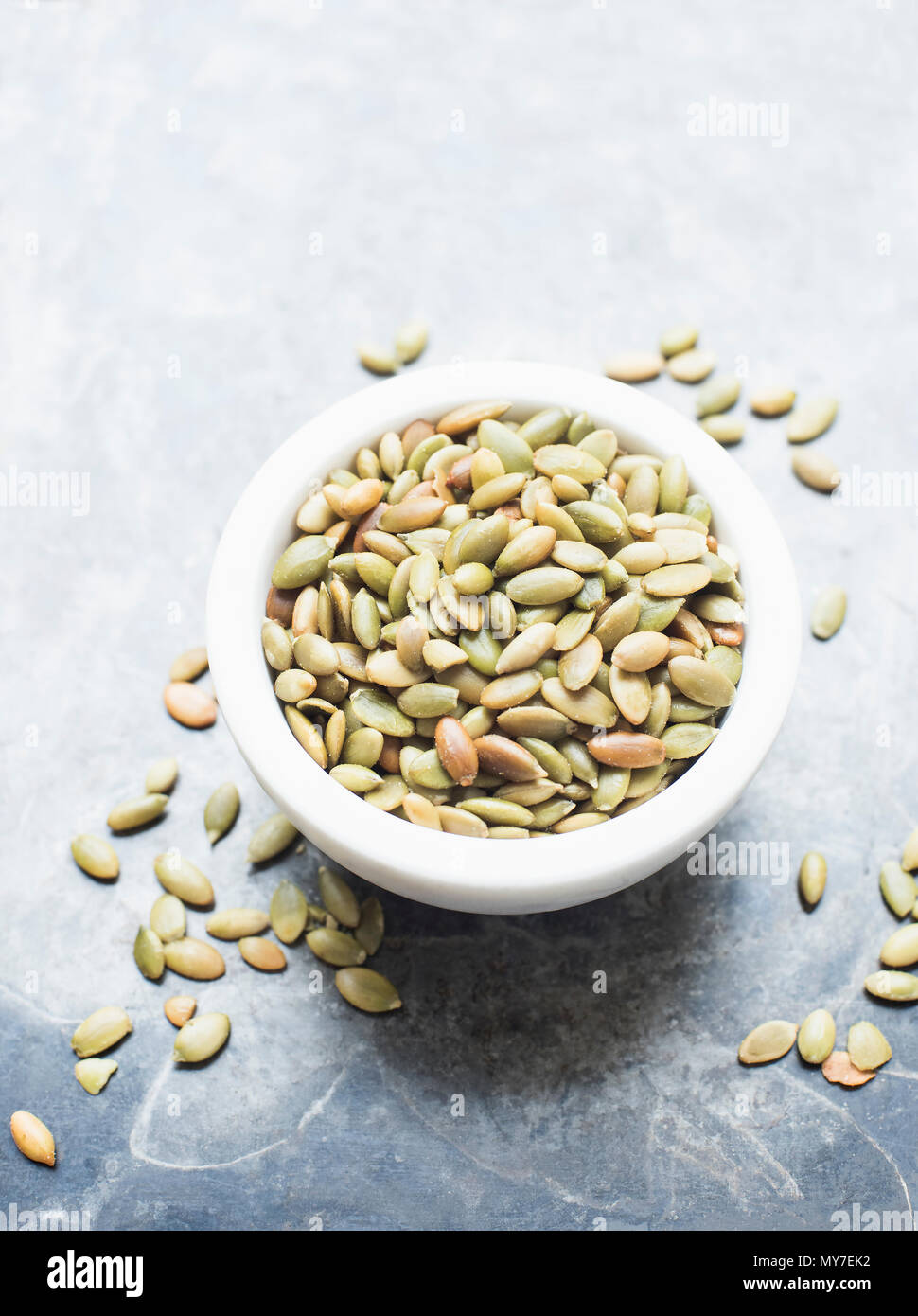 Pumpkin seeds in a bowl, close up overhead view Stock Photo