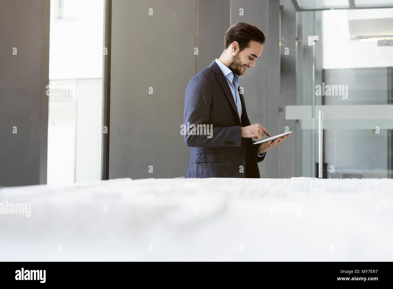Businessman in office using digital tablet Stock Photo
