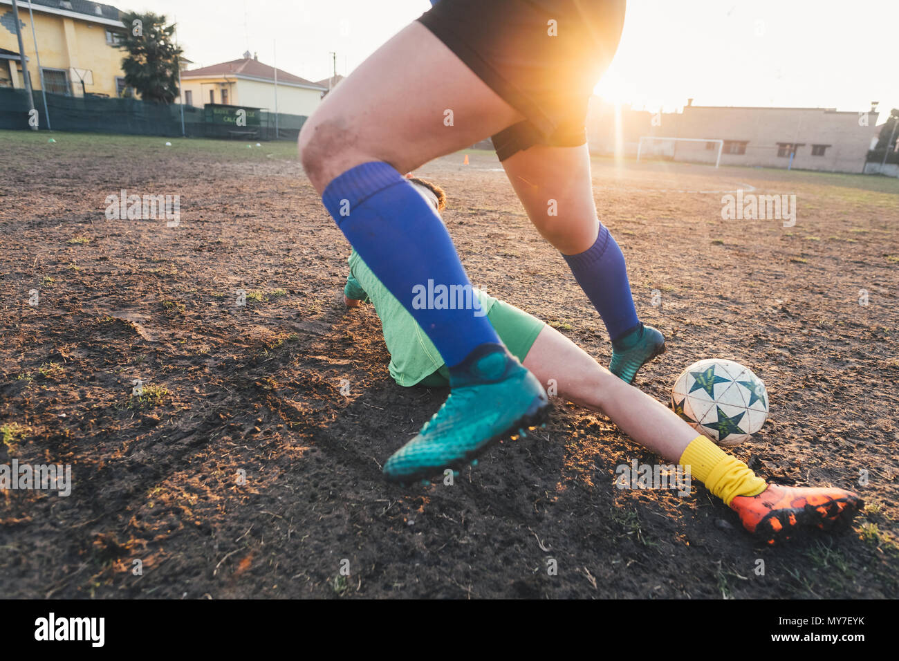 Footballers playing on pitch Stock Photo