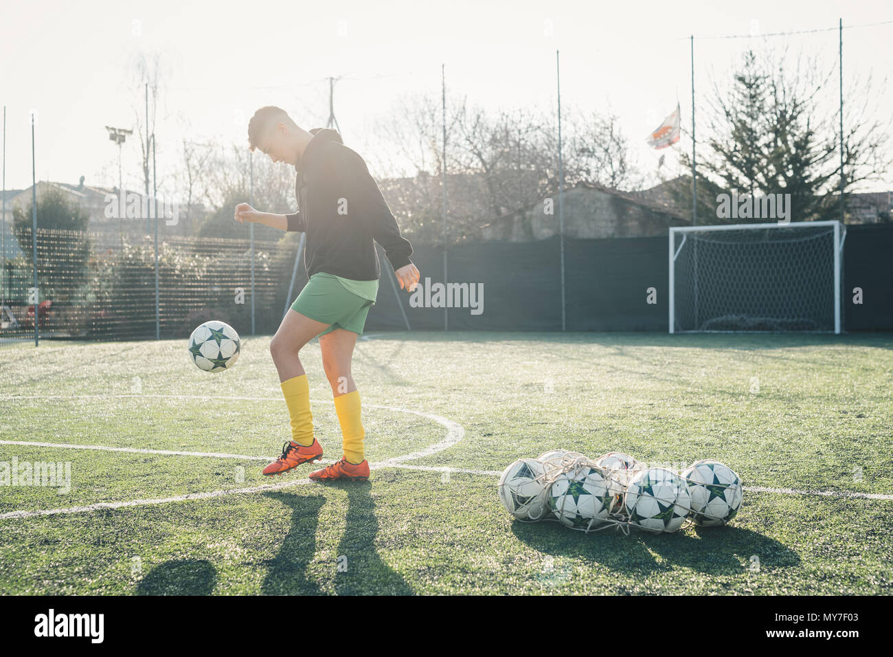 Football player practising on football pitch Stock Photo