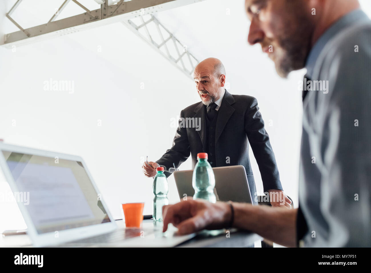 Businessman talking with colleagues Stock Photo