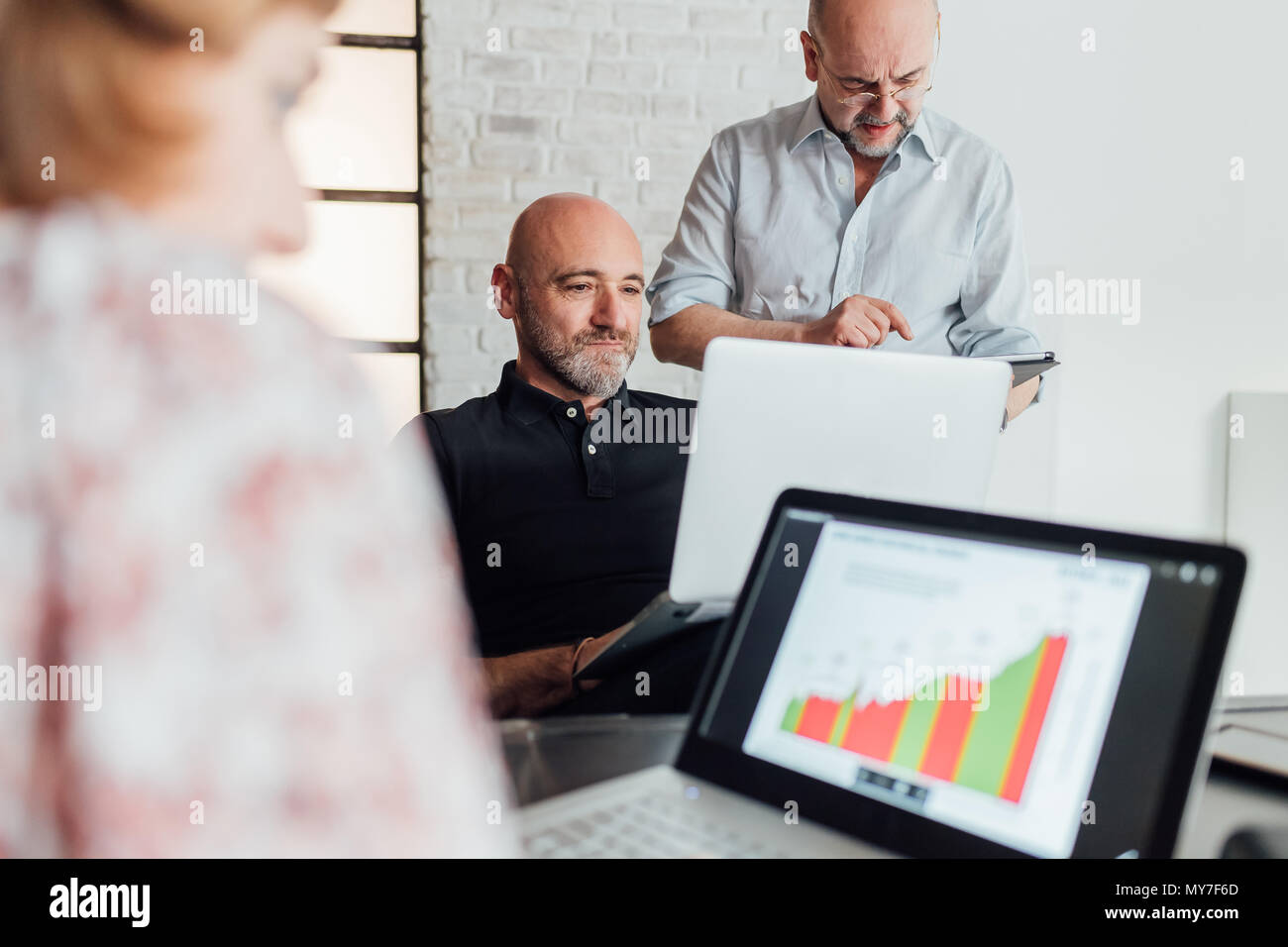 Colleagues using laptops Stock Photo
