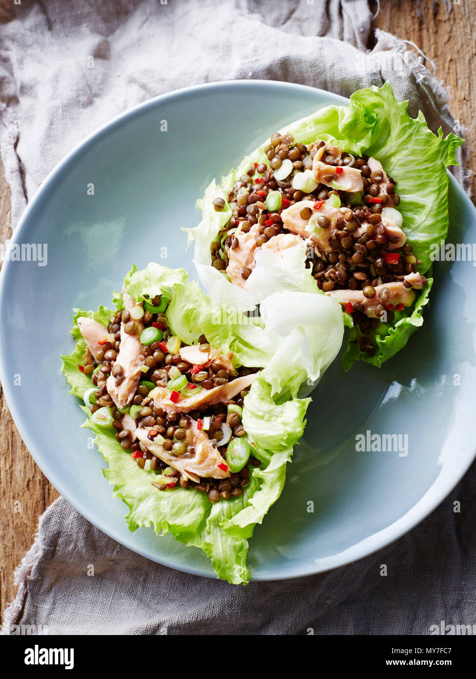 Smoked trout and lentil lettuce cups, on plate, close-up Stock Photo