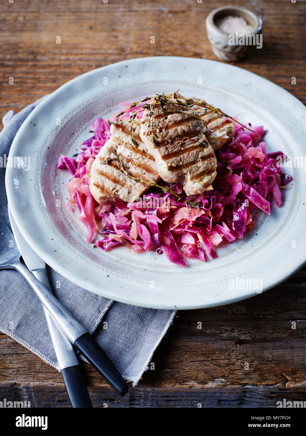 Grilled pork on braised red cabbage, close-up Stock Photo