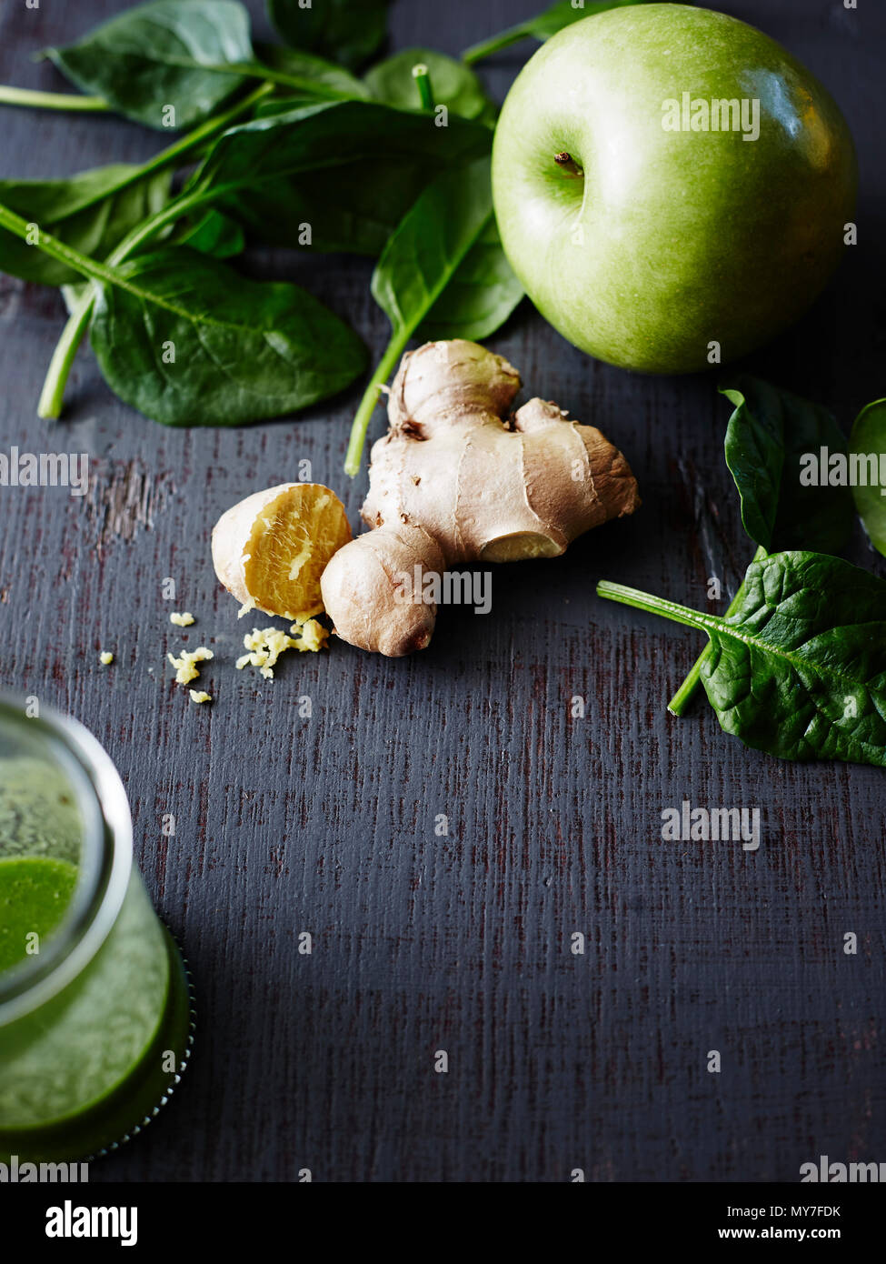 Still life of kale, apple. fresh ginger and basil leaves, close-up Stock Photo