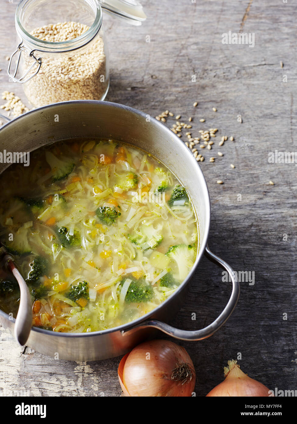 Still life of chicken and vegetable soup with barley in saucepan, overhead view Stock Photo