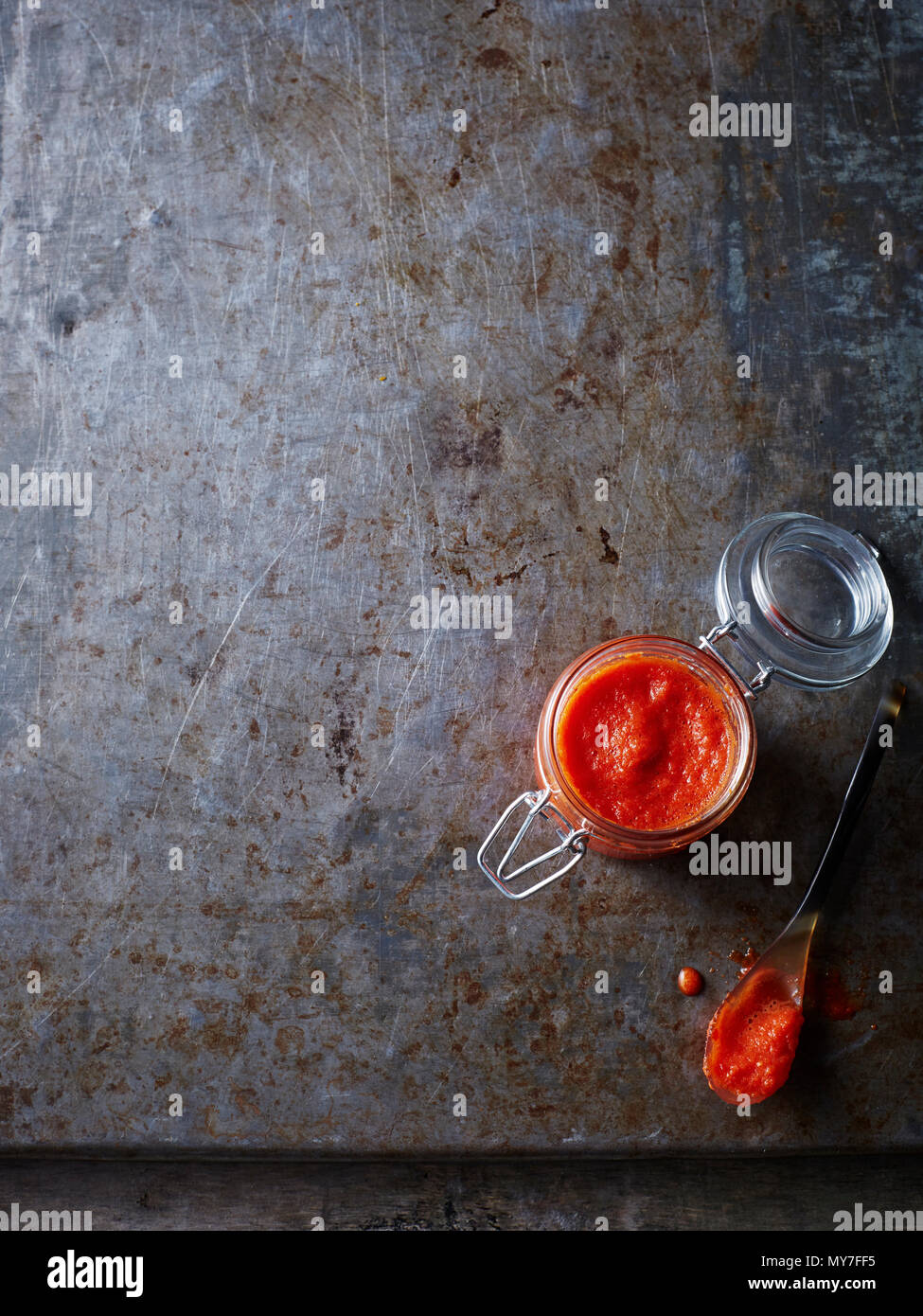 Still life of jar of homemade chilli sauce , overhead view Stock Photo