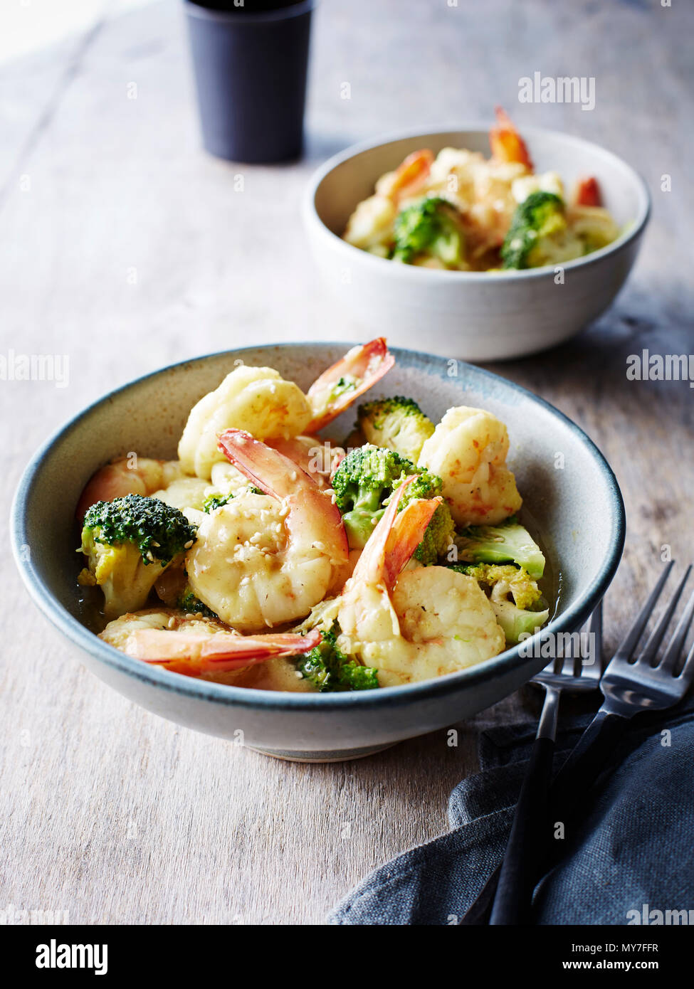 Still life with bowls of chinese mustard prawns and broccoli Stock Photo