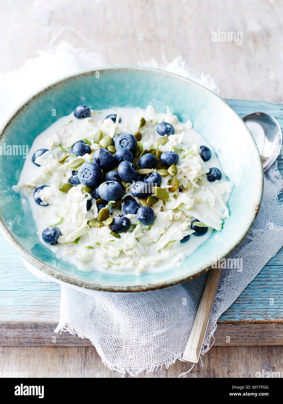 Still life with bowl of fresh blueberries and apple oats Stock Photo