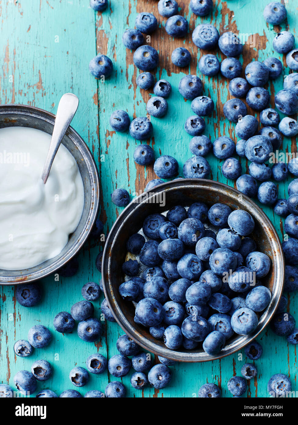 Still life with bowl of blueberries and yogurt, overhead view Stock Photo