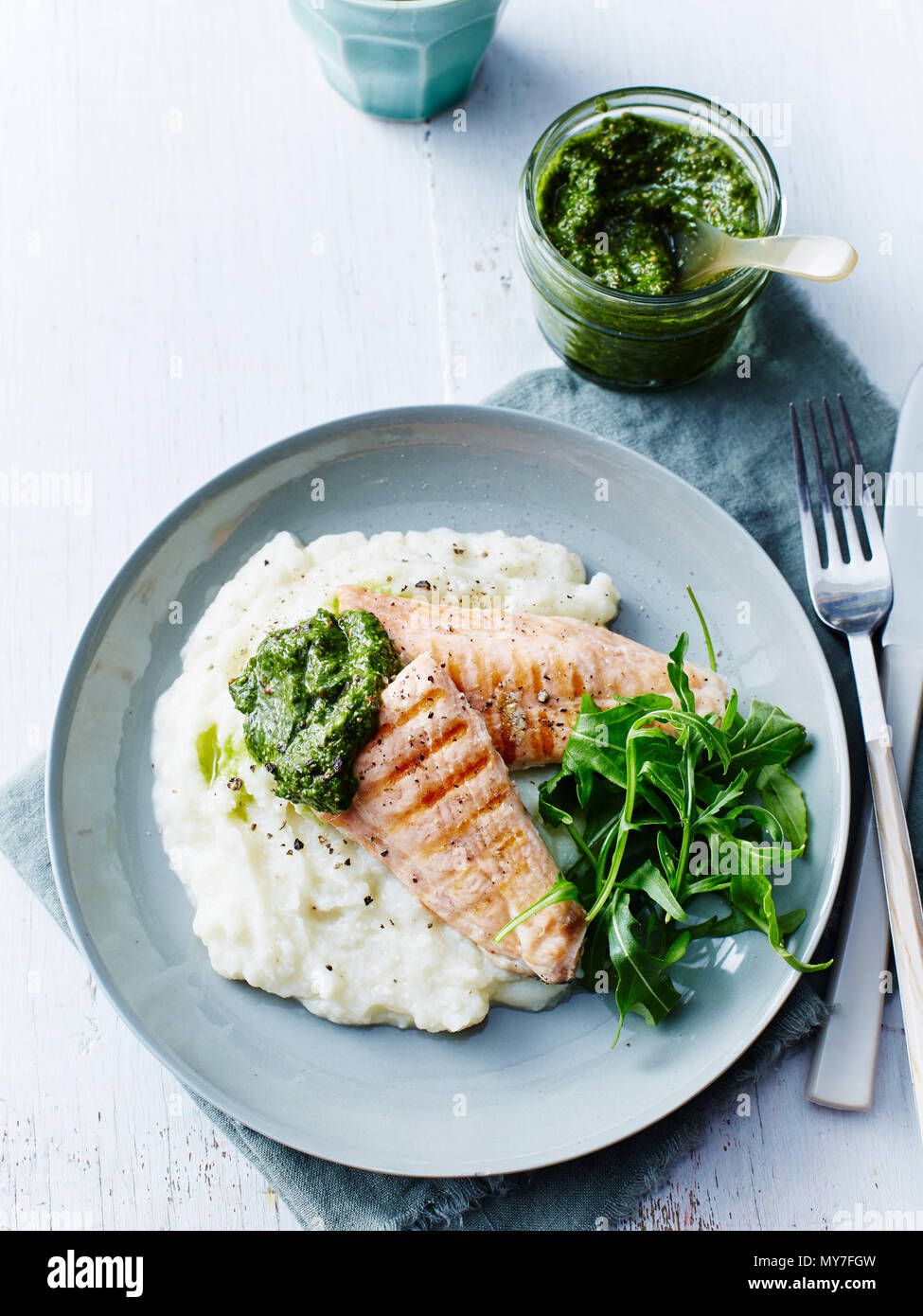 Still life with plate of grilled salmon, rocket and cauliflower puree, overhead view Stock Photo