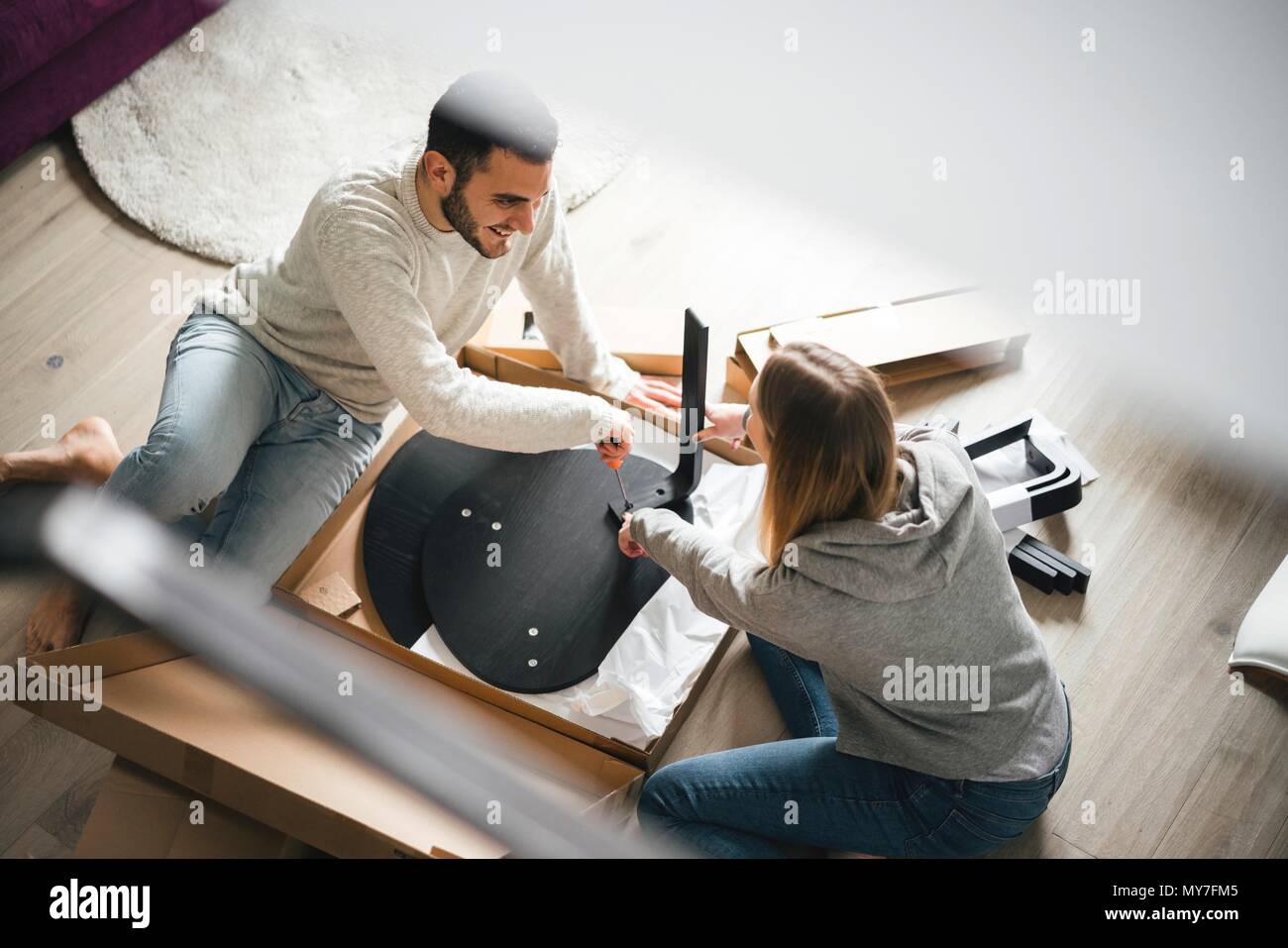 Couple assembling flat pack furniture Stock Photo