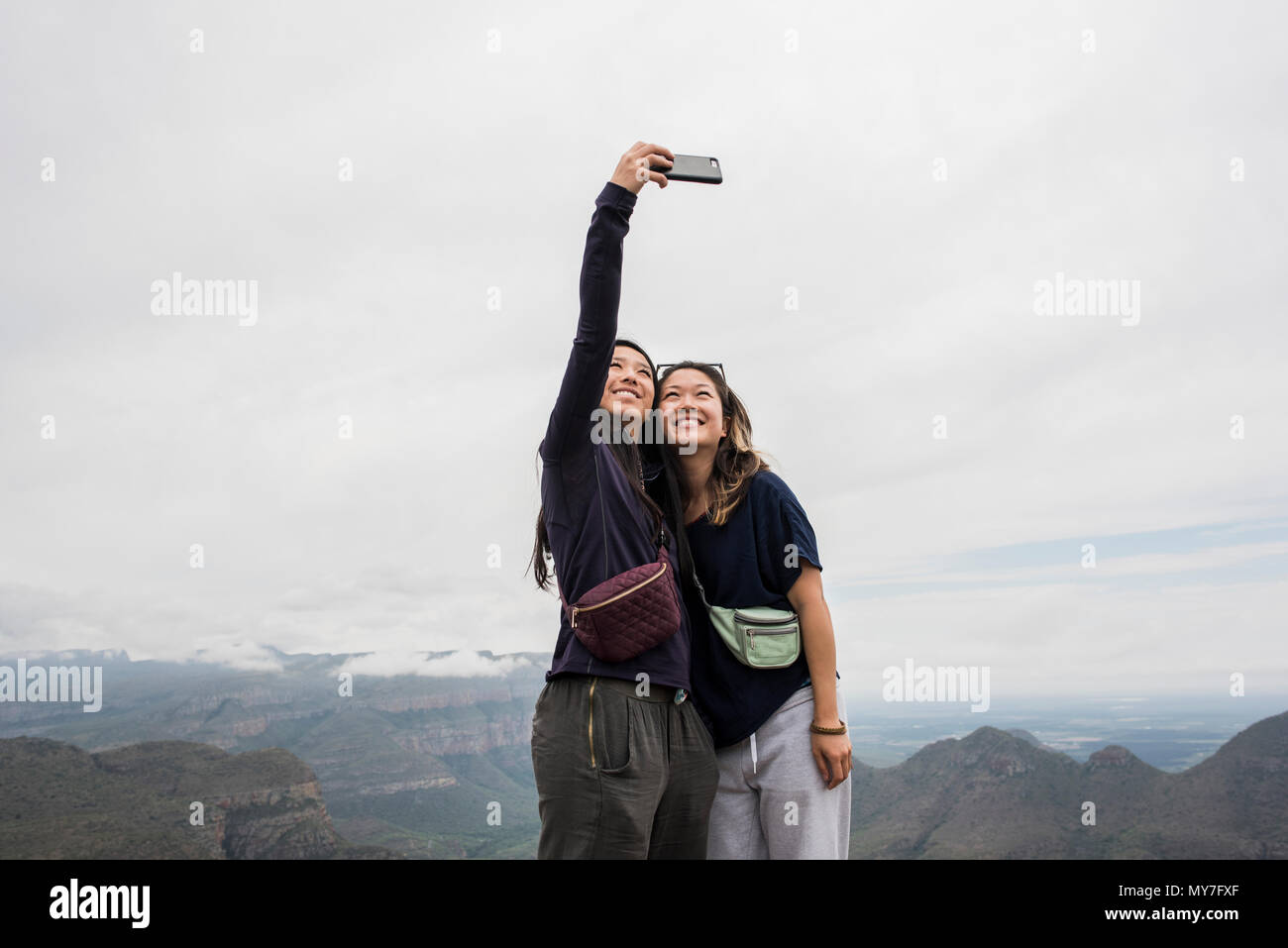 Two young female tourists taking selfie from The Three Rondavels, Mpumalanga, South Africa Stock Photo