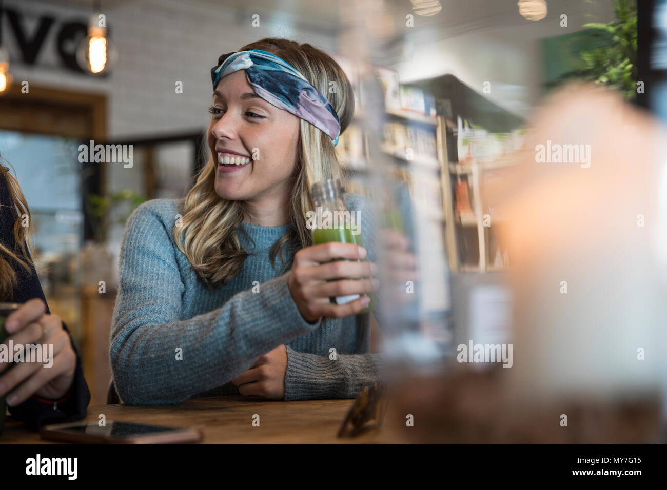 Female friends, sitting in cafe, catching up, drinking smoothies Stock Photo