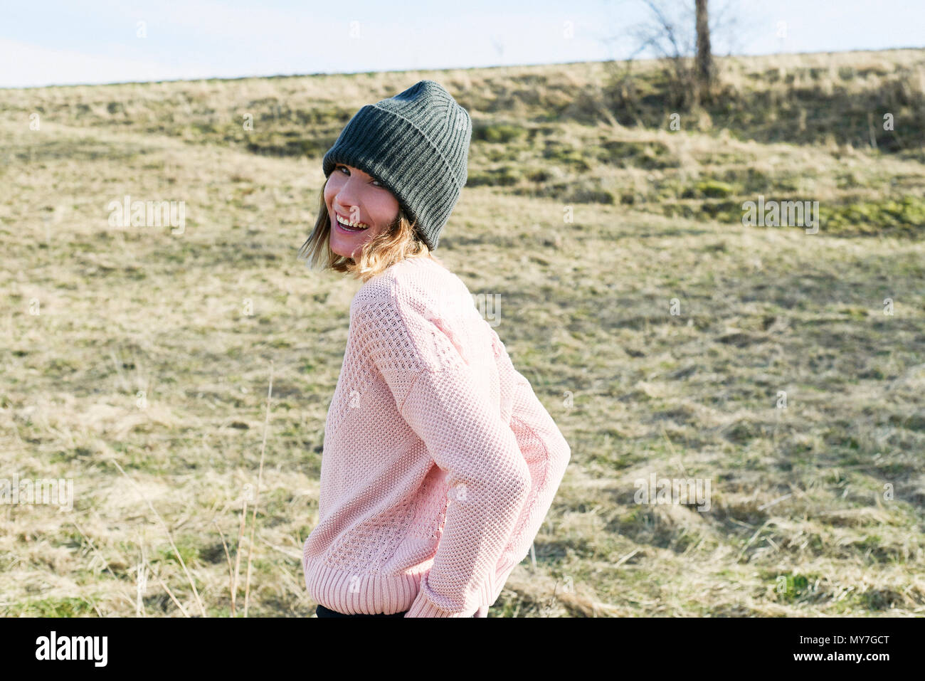 Portrait of mid adult woman wearing knitted hat in field Stock Photo