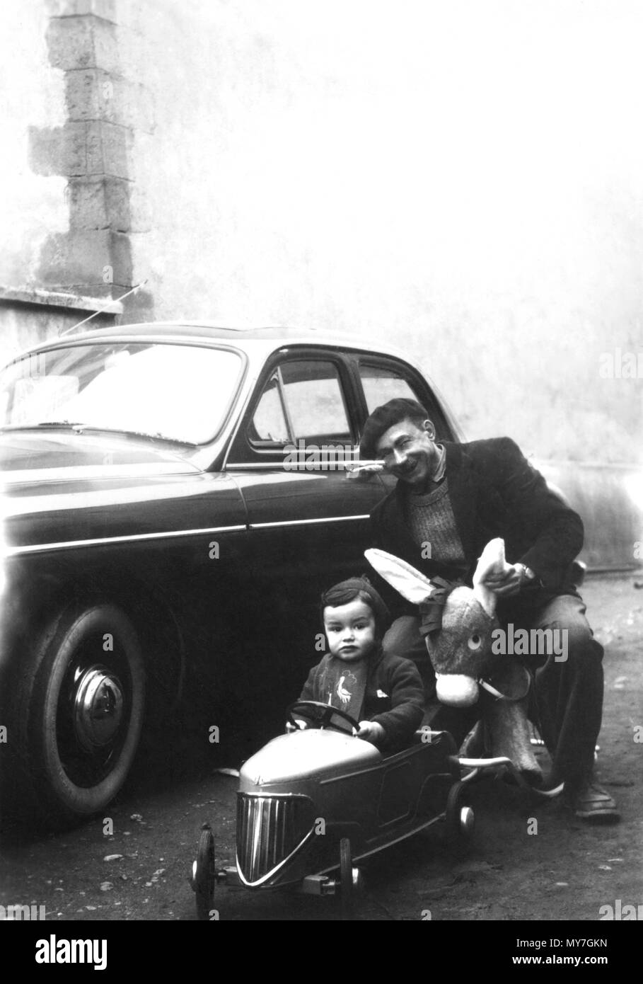 Old photograph, father and son with a toy car and rocking horse, France Stock Photo