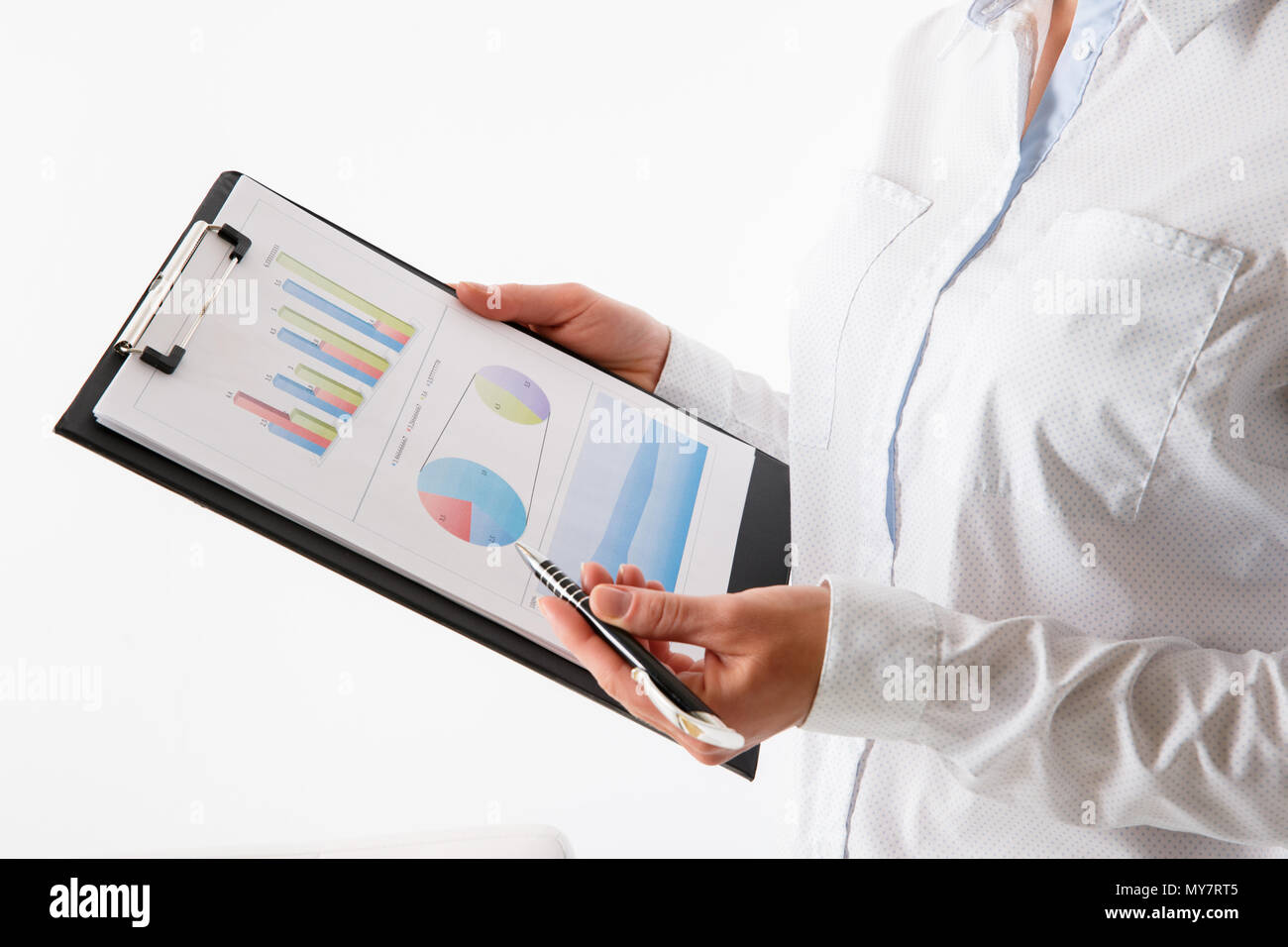 Business woman pointing at graph document close-up. Young business ...