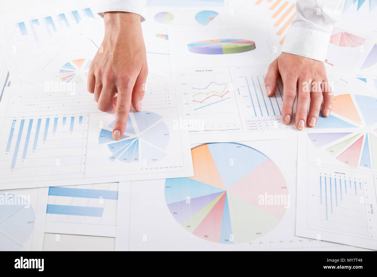 Business woman pointing at graph document close-up. Young business ...