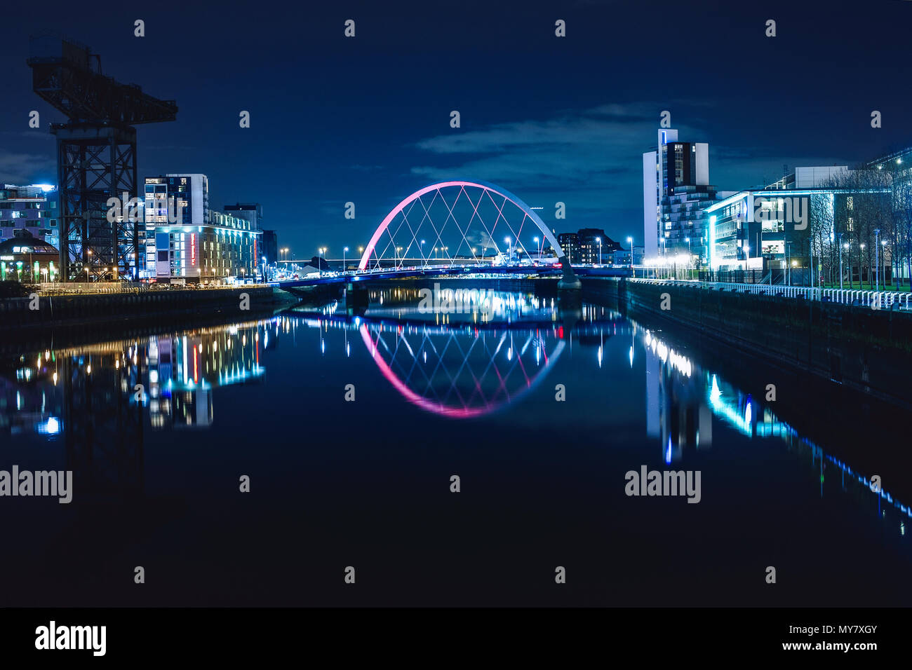 Night view of the Clyde Arc or Squinty Bridge from the East and river Clyde, Glasgow, Scotland Stock Photo