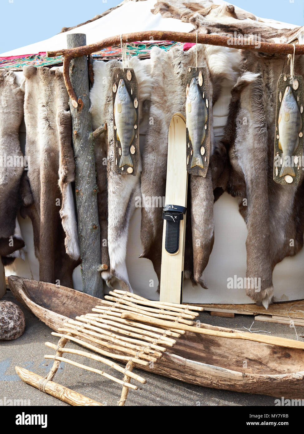 Hunter skis, wooden boat and reindeer skins on a yurt Stock Photo