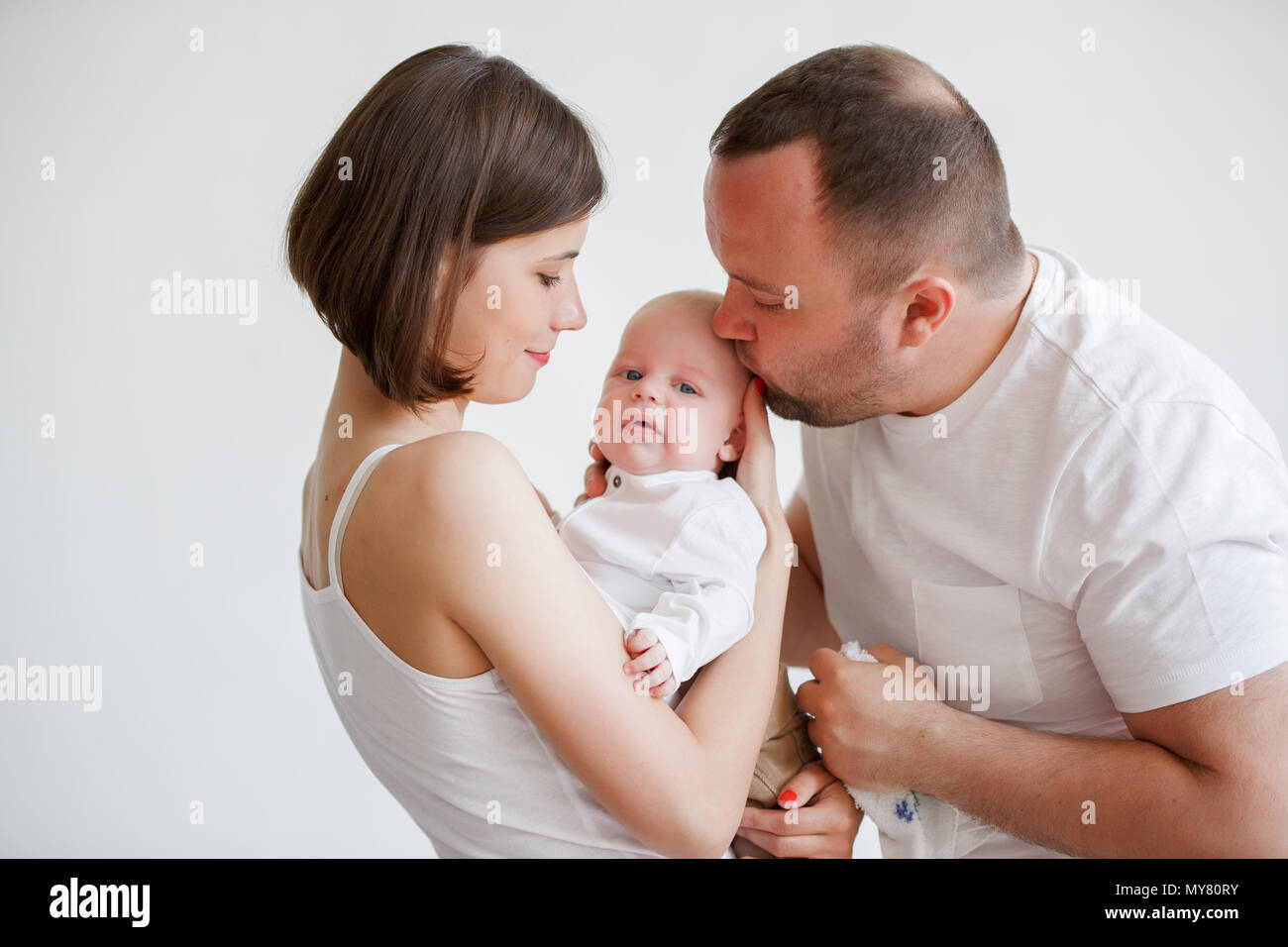 Photo of cuddling parents with newborn son in room Stock Photo - Alamy